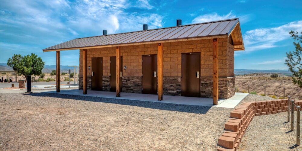 three stall vault restroom in the desert