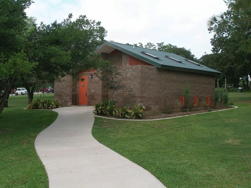 Large Shower Facility with Orange Steel Doors and Green Roof