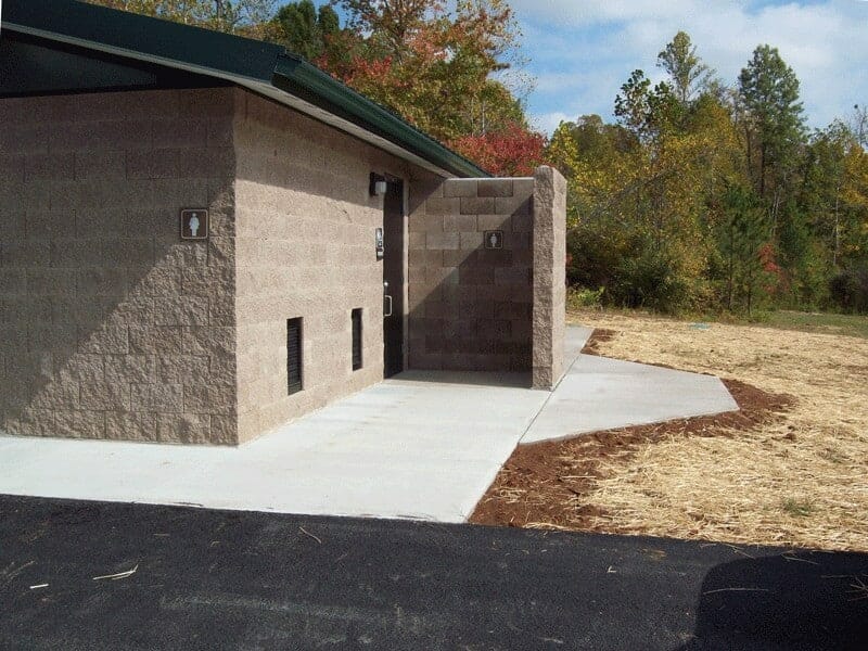 shower-restroom-with-concrete-exterior-and-side-entry Privacy Wall Entrance to Shower and Restroom Building
