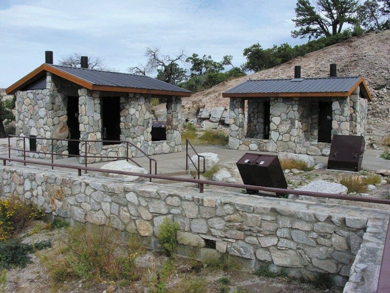 Pair of Waterless Restrooms with Matching Stone Exteriors