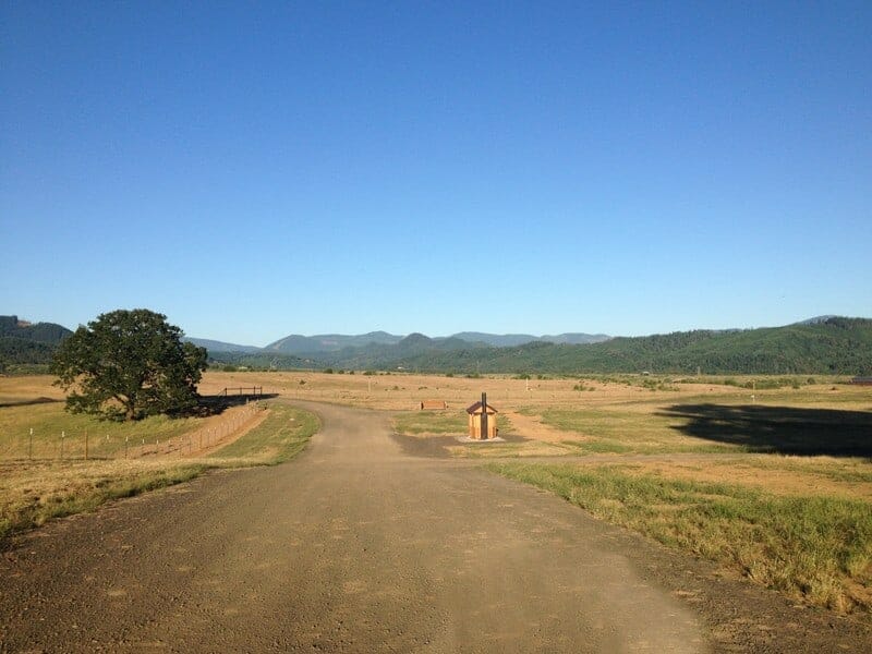 Antiquated Memorial Park with Dirt Road and Vault Restroom