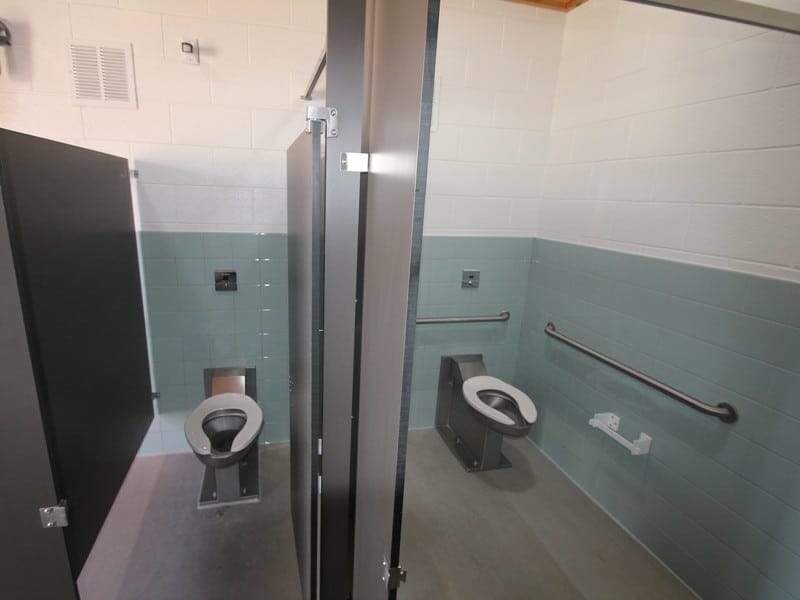 Interior Wall Tile and White Painted CMU with Steel Toilets