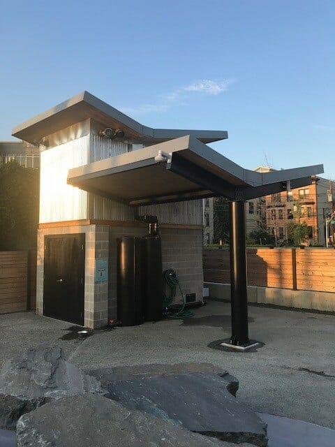 Utility Building with Unique V-Shaped Roof and Covered Area