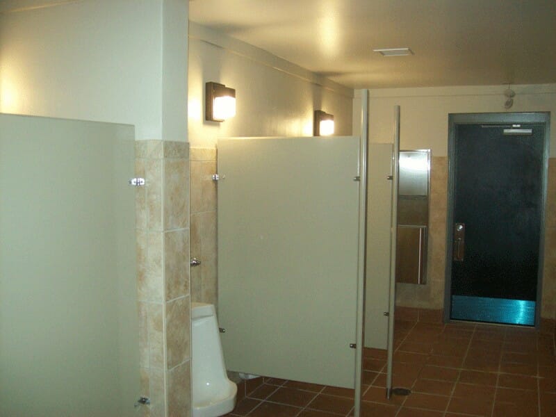 Interior with Porcelain Urinal and Steel Barriers and Tile Walls
