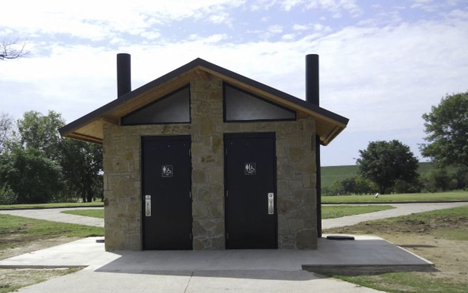 Medium Waterless Restroom with Stone Exterior Siding at Golf Course