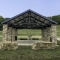Large Steel Pavilion with Stone Columns to Match Surrounding Environment