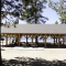 Large Log Pavilion Covering Picnic Area at Lake