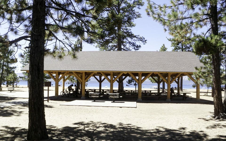 Large Log Pavilion Covering Picnic Area at Lake