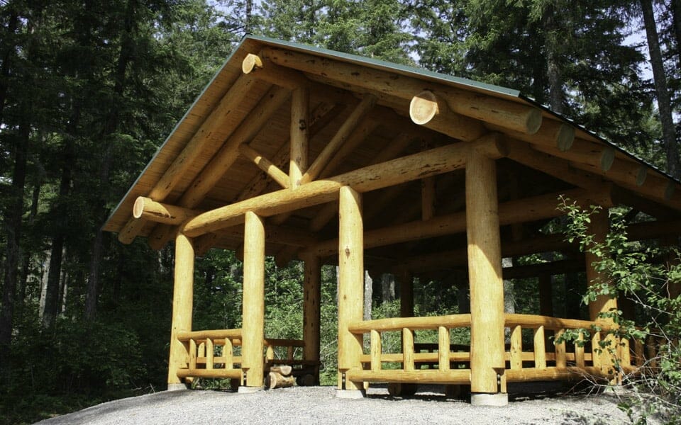 Log shelter with log railings and green roofing