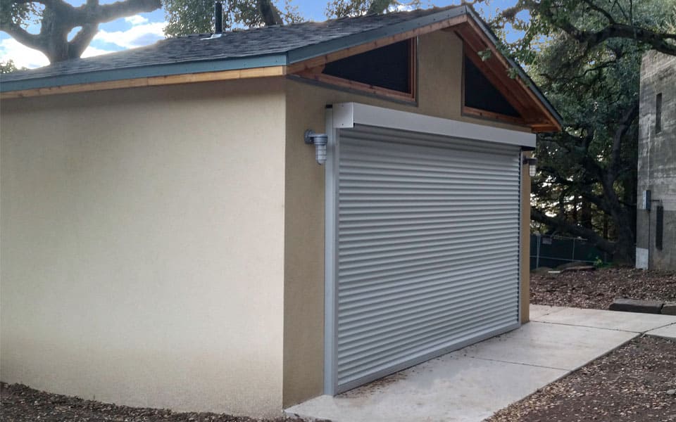 small-storage-equipment-building-with-rollup-door Small Storage Building with Steel Rollup Door and Stucco Exterior