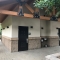 Large Bathroom Facility with Stucco Siding and Roof Extension over Walkway