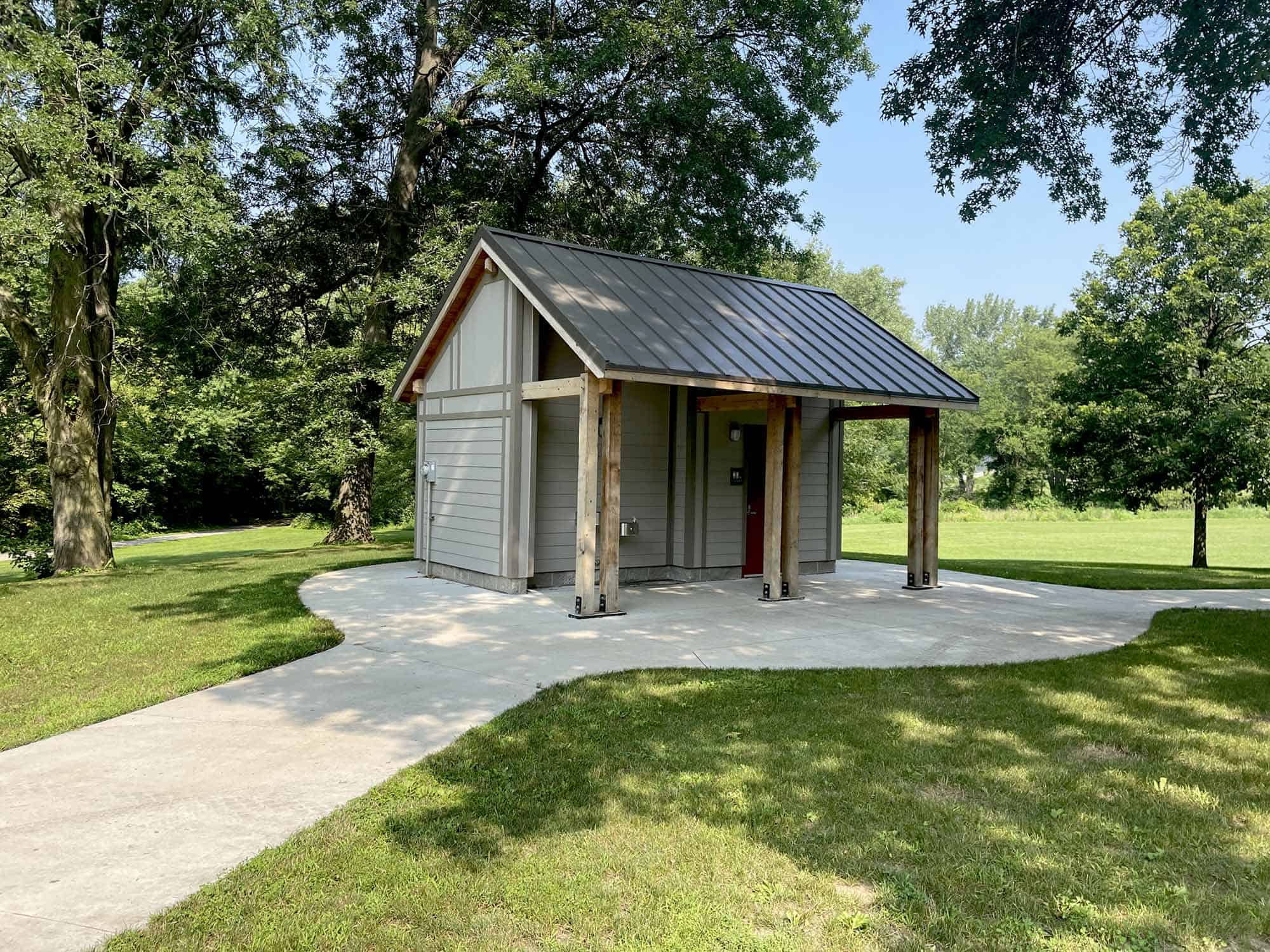 Custom park bathroom with lumber columns on roof extension