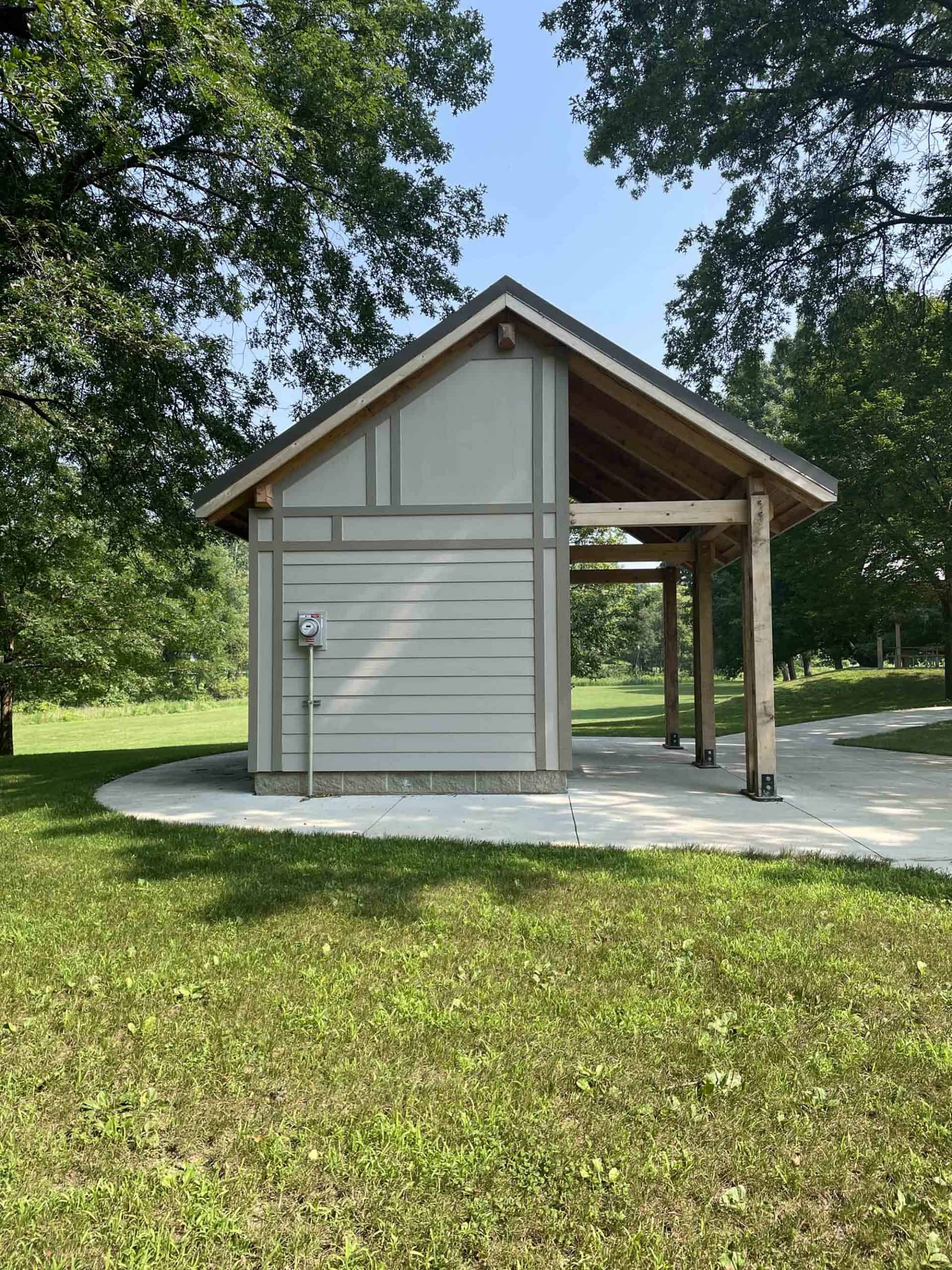 Custom public bathroom with lap siding and roof extension