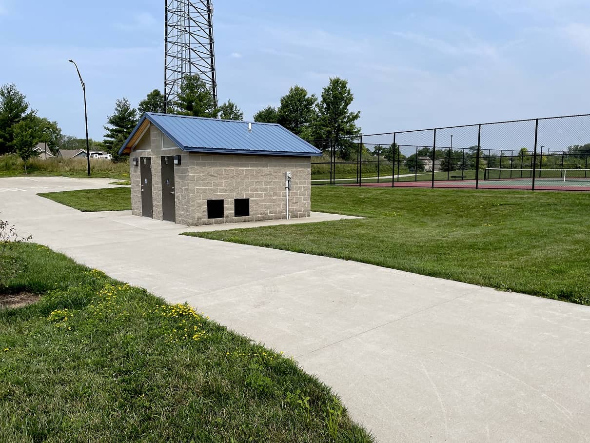 restroom building with blue steel roofing and cement block structure