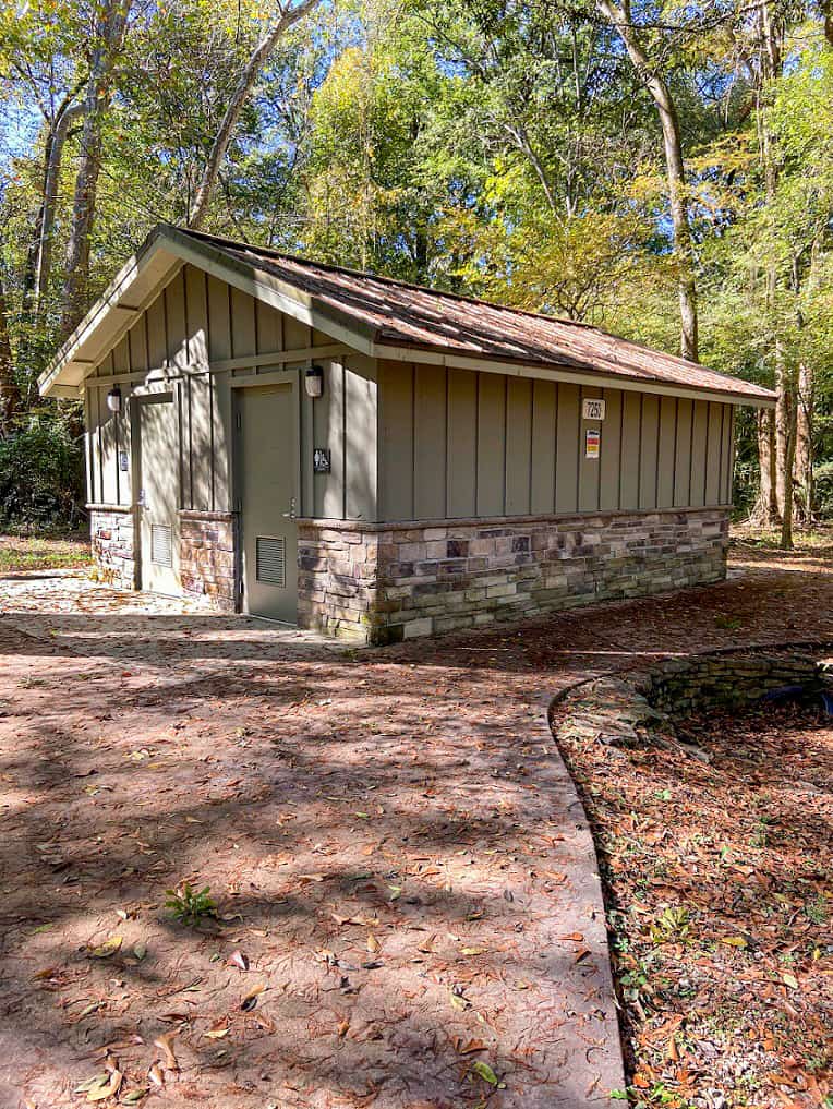 Campground restroom with sage green painted board and batten and stone wainscot