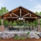 Large Shelter with Stone Columns and Dark Green Metal Roofing