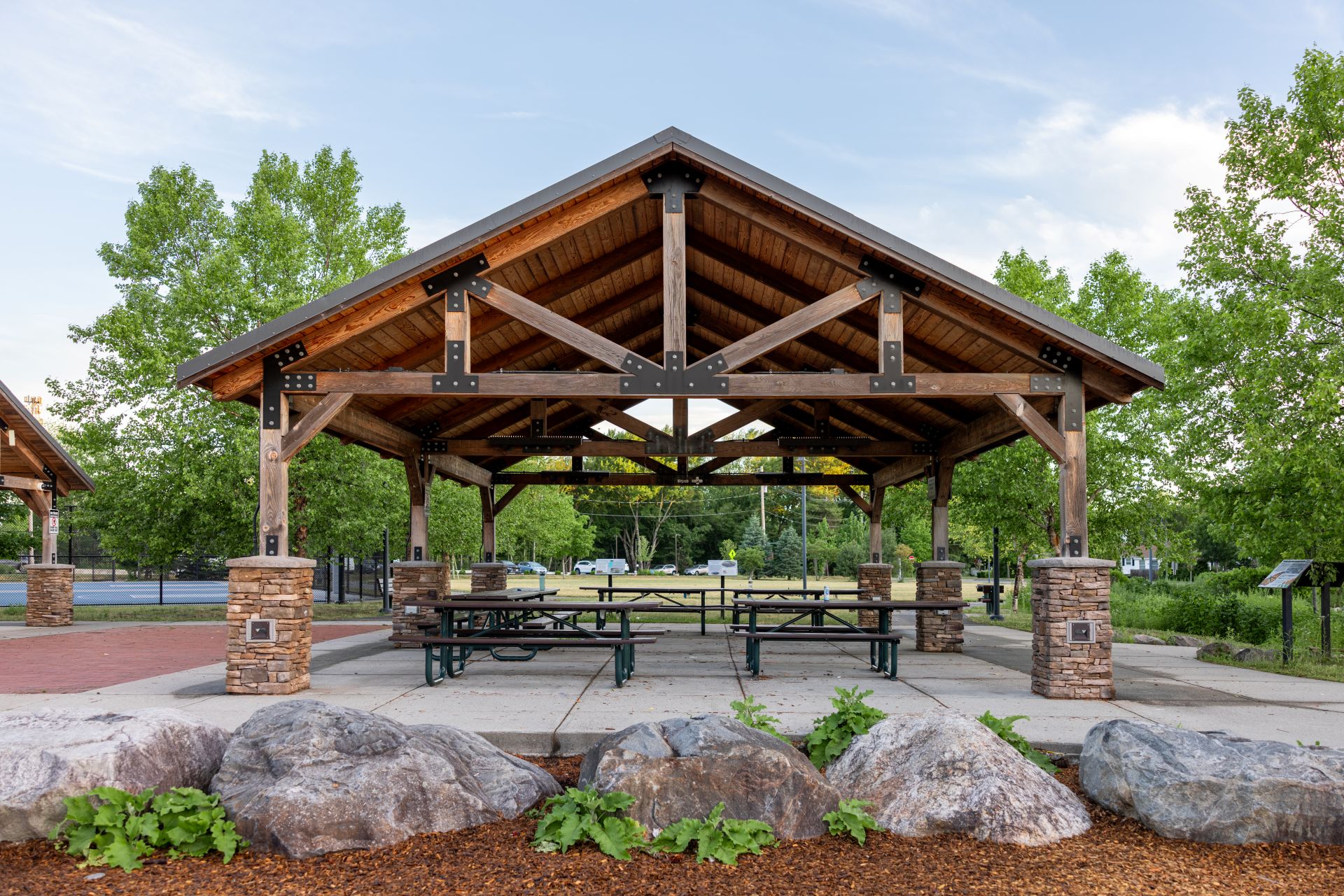 Large Shelter with Stone Columns and Dark Green Metal Roofing