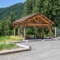 large log post pavilion with natural floor and picnic tables